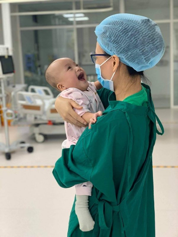 Hình ảnh Trúc Nhi tươi cười trên vòng tay mẹ (Ảnh: BV Nhi đồng Thành phố)
